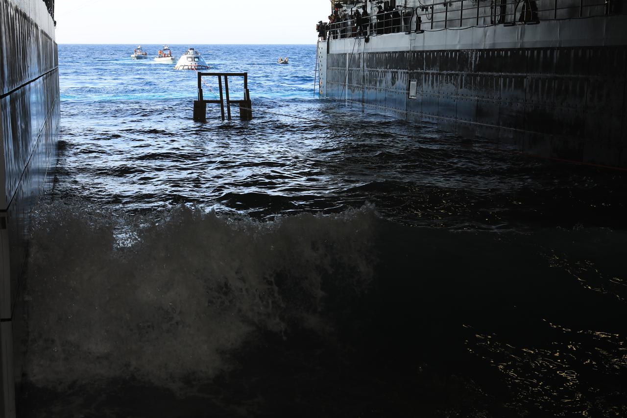 The Exploration Ground Systems Recovery Team, based out of Kennedy Space Center in Florida, along with the U.S. Navy, prepare to pull a test version of the Orion capsule inside the well deck of the USS John P. Murtha during Underway Recovery Test-7 (URT-7) on Oct. 31, 2018, in the Pacific Ocean. URT-7 is one in a series of tests to verify and validate procedures and hardware that will be used to recover the Orion spacecraft after it splashes down in the Pacific Ocean following deep space exploration missions. Orion will have emergency abort capability, sustain the crew during space travel and provide safe re-entry from deep space return velocities.