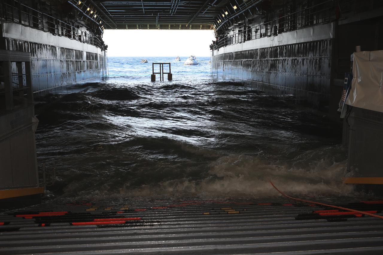 The Exploration Ground Systems Recovery Team, based out of Kennedy Space Center in Florida, along with the U.S. Navy, prepare to pull a test version of the Orion capsule inside the well deck of the USS John P. Murtha during Underway Recovery Test-7 (URT-7) on Oct. 31, 2018, in the Pacific Ocean. URT-7 is one in a series of tests to verify and validate procedures and hardware that will be used to recover the Orion spacecraft after it splashes down in the Pacific Ocean following deep space exploration missions. Orion will have emergency abort capability, sustain the crew during space travel and provide safe re-entry from deep space return velocities.