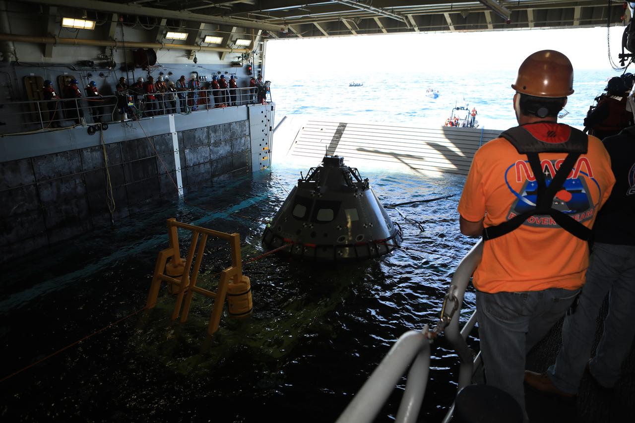 The Exploration Ground Systems Recovery Team, based out of Kennedy Space Center in Florida, practices bringing a test version of the Orion capsule inside the flooded well deck of the USS John P. Murtha and setting it in a cradle as part of Underway Recovery Test-7 (URT-7) on Oct. 31, 2018, in the Pacific Ocean. URT-7 is one in a series of tests to verify and validate procedures and hardware that will be used to recover the Orion spacecraft after it splashes down in the Pacific Ocean following deep space exploration missions. Orion will have emergency abort capability, sustain the crew during space travel and provide safe re-entry from deep space return velocities.
