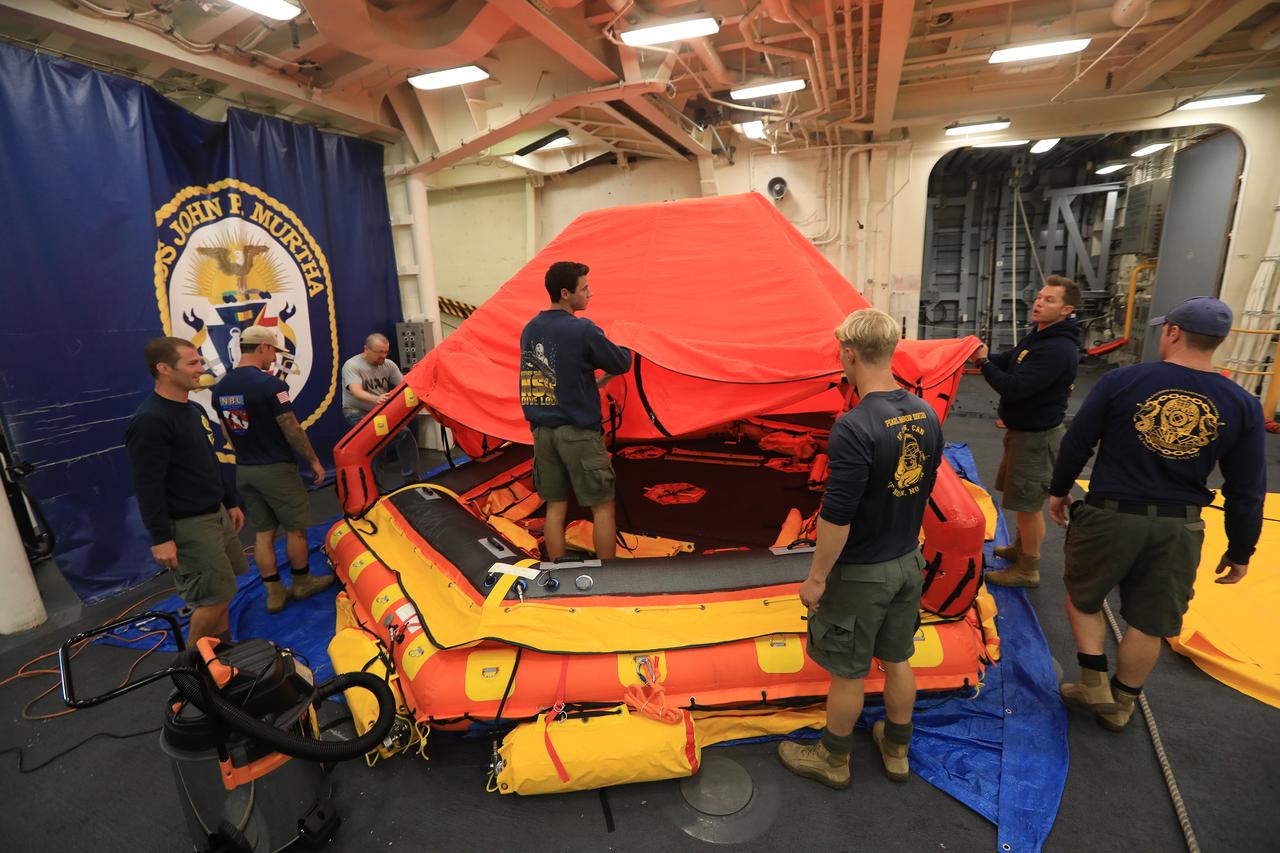 U.S. Navy divers practice assembling the "front porch" before doing so in the open water during Underway Recovery Test-7 (URT-7) on Nov. 1, 2018, in the Pacific Ocean. During recovery operations, future astronauts will have the choice to stay in the Orion capsule while it is pulled into the well deck of a U.S. Navy ship, or be pulled out immediately on the front porch until taken by small boat back to the ship. The Exploration Ground Systems recovery team and the U.S. Navy are working together to verify and validate procedures and hardware that will be used to recover the Orion spacecraft after it splashes down in the Pacific Ocean following deep space exploration missions. Orion will have emergency abort capability, sustain the crew during space travel and provide safe re-entry from deep space return velocities.