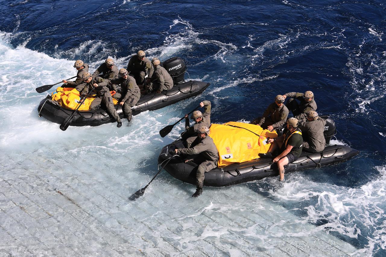U.S. Navy divers push off from the well deck of the USS John P. Murtha to practice recovery of the Orion crew capsule in the open water as part of Underway Recovery Test-7 (URT-7) on Nov. 1, 2018. URT-7 is one in a series of tests that the Exploration Ground Systems Recovery Team and U.S. Navy are performing to verify and validate procedures and hardware that will be used to recover the Orion spacecraft after it splashes down in the Pacific Ocean following deep space exploration missions. Orion will have emergency abort capability, sustain the crew during space travel and provide safe re-entry from deep space return velocities.