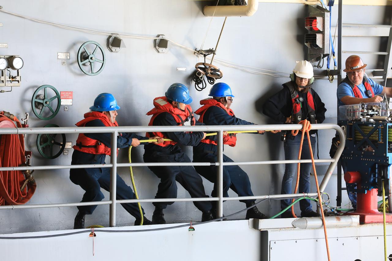 During Underway Recovery Test-7 (URT-7), NASA's Recovery Team watches the U.S. Navy crew man the tending lines when bringing the Orion capsule into the well deck of a ship on Nov. 1, 2018, aboard the USS John P. Murtha. URT-7 is one in a series of tests to verify and validate procedures and hardware that will be used to recover the Orion spacecraft after it splashes down in the Pacific Ocean following deep space exploration missions. Orion will have emergency abort capability, sustain the crew during space travel and provide safe re-entry from deep space return velocities.