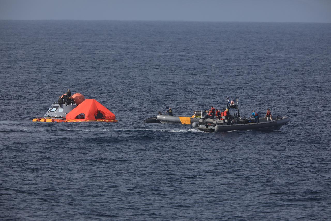 During Underway Recovery Test-7 (URT-7), U.S. Navy divers practice attaching the "front porch" on a test version of the Orion capsule. During recovery operations, future astronauts aboard Orion will have the choice to stay in the capsule while it is pulled into the well deck of a Navy ship, or be pulled out immediately and put on the front porch until taken by small boat back to the ship. URT-7 is one in a series of tests to verify and validate procedures and hardware that will be used to recover the Orion spacecraft after it splashes down in the Pacific Ocean following deep space exploration missions. Orion will have emergency abort capability, sustain the crew during space travel and provide safe re-entry from deep space return velocities.