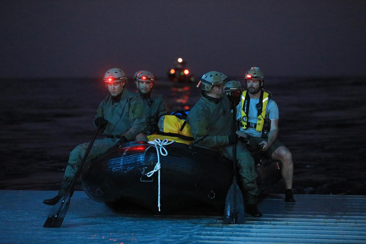 U.S. Navy divers prepare to deploy for night operations on Nov. 3, 2018, during Underway Recovery Test-7 (URT-7) in the well deck of the USS John P. Murtha. NASA's Recovery Team is testing to verify and validate procedures and hardware that will be used to recover the Orion spacecraft after it splashes down in the Pacific Ocean following deep space exploration missions. Orion will have emergency abort capability, sustain the crew during space travel and provide safe re-entry from deep space return velocities.