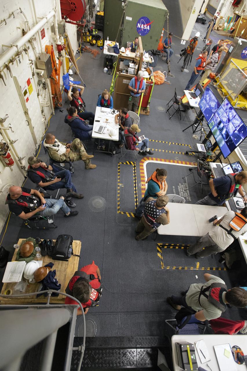NASA Recovery Team members monitor activities during Underway Recovery Test-7 (URT-7) in the well deck of the USS John P. Murtha on Nov. 4, 2018. During URT-7, the team practices recovering a test version of the Orion capsule from the Pacific Ocean and towing it into the well deck of the ship. URT-7 is one in a series of tests conducted by the Exploration Ground Systems Recovery Team to verify and validate procedures and hardware that will be used to recover the Orion spacecraft after it splashes down in the Pacific Ocean following deep space exploration missions. Orion will have emergency abort capability, sustain the crew during space travel and provide safe re-entry from deep space return velocities.