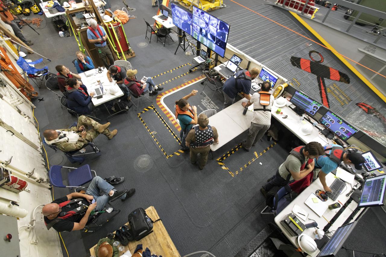 NASA Recovery Team members monitor activities during Underway Recovery Test-7 (URT-7) in the well deck of the USS John P. Murtha on Nov. 4, 2018. During URT-7, the team practices recovering a test version of the Orion capsule from the Pacific Ocean and towing it into the well deck of the ship. URT-7 is one in a series of tests conducted by the Exploration Ground Systems Recovery Team to verify and validate procedures and hardware that will be used to recover the Orion spacecraft after it splashes down in the Pacific Ocean following deep space exploration missions. Orion will have emergency abort capability, sustain the crew during space travel and provide safe re-entry from deep space return velocities.
