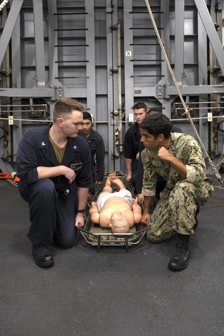 U.S. Navy recovery team members practice bringing an astronaut aboard the USS John P. Murtha, using a dummy, during Underway Recovery Test-7 (URT-7) on Nov. 5, 2018. NASA's Recovery Team, along with the U.S. Navy, are practicing recovery of a test version of the Orion in the Pacific Ocean. URT-7 is one in a series of tests to verify and validate procedures and hardware that will be used to recover the Orion spacecraft after it splashes down in the Pacific Ocean following deep space exploration missions. Orion will have emergency abort capability, sustain the crew during space travel and provide safe re-entry from deep space return velocities.