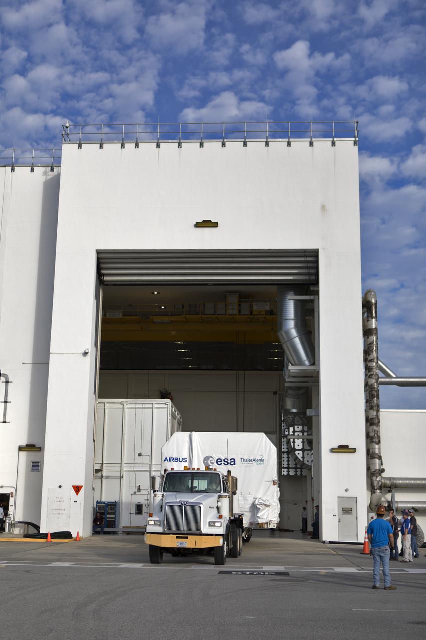 A flatbed truck carrying the European Space Agency's European Service Module (ESM) in its shipping container backs into the airlock of the Neil Armstrong Operations and Checkout Building on Nov. 6, 2018, at NASA's Kennedy Space Center in Florida. The ESM will supply the main propulsion system and power to the Orion spacecraft for Exploration Mission-1 (EM-1), a mission to the Moon. The ESM also will house air and water for astronauts on future missions. EM-1 will be an uncrewed flight test that will provide a foundation for human deep space exploration to destinations beyond Earth orbit. EM-1 will be the first integrated test of NASA's Space Launch System, Orion and the ground systems at Kennedy.