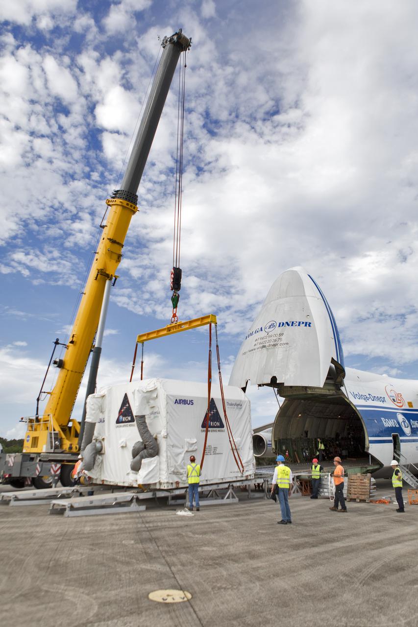 A crane is attached to the shipping container holding the European Service Module (ESM) after it was moved out of the cargo hold of the Antonov cargo aircraft at the Shuttle Landing Facility at NASA's Kennedy Space Center in Florida on Nov. 6, 2018. The ESM, built by the European Space Agency, will supply the main propulsion system and power to the Orion spacecraft for Exploration Mission-1 (EM-1), a mission to the Moon. The ESM also will house air and water for astronauts on future missions. EM-1 will be an uncrewed flight test that will provide a foundation for human deep space exploration to destinations beyond Earth orbit. EM-1 will be the first integrated test of NASA's Space Launch System, Orion and the ground systems at Kennedy.