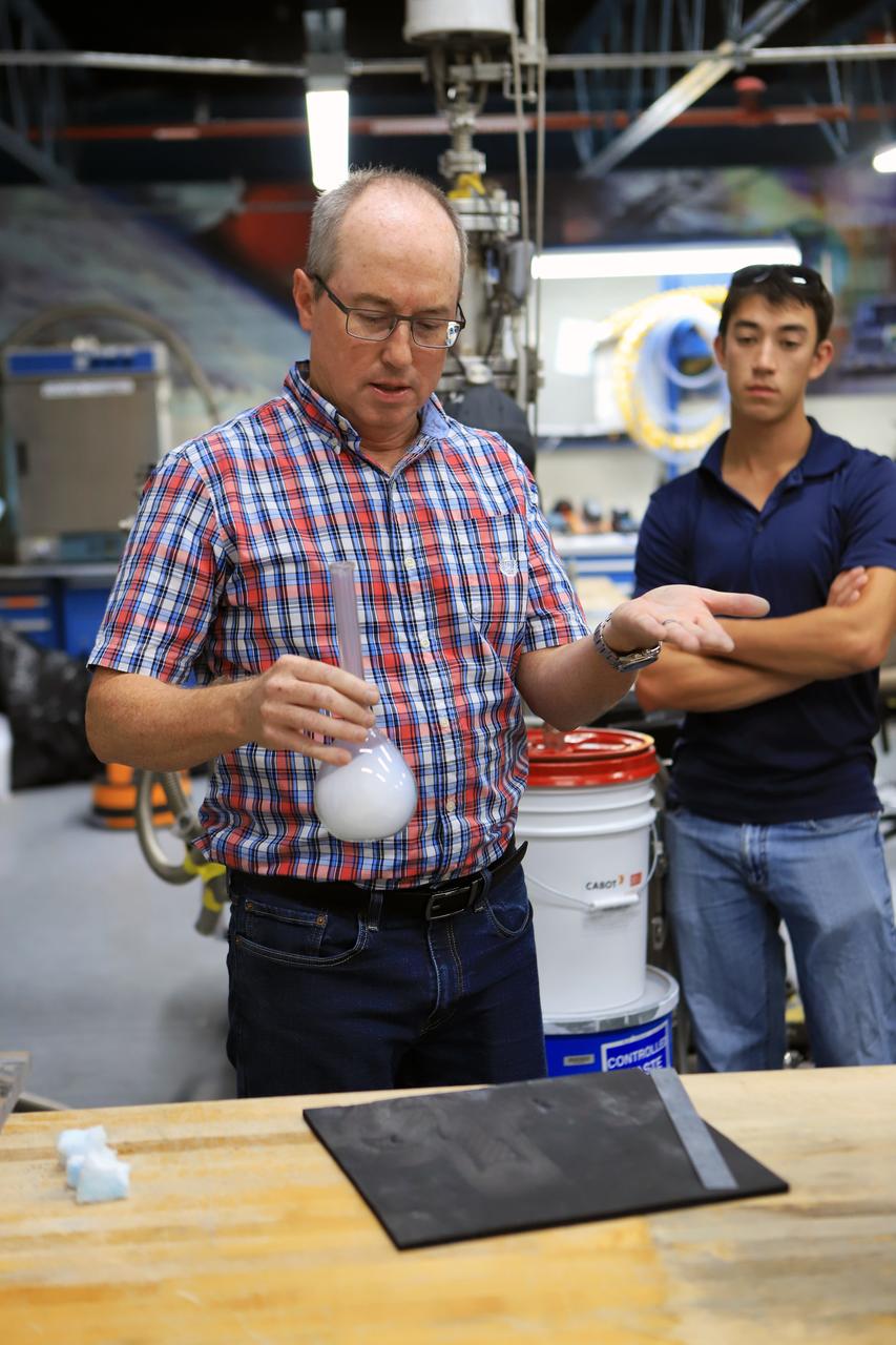 James Fesmire, Ph.D., left, NASA lead engineer for the Cryogenics Testbed, and Adam Swanger, cryogenics engineer, hold a training session on Nov. 6, 2018, at the Cryogenics Laboratory at NASA's Kennedy Space Center in Florida. The training is for personnel who will be working to insulate pipes on the mobile launcher (ML). The ML is equipped with cryogenic fluid lines that will deliver hydrogen and oxygen to NASA's Space Launch System rocket. The lines must be kept well-insulated to maintain temperatures cold enough to keep fluids in a liquid state. In a new process, workers are learning how to pack spaces between pipes with aerogel granules in the same manner as they will on the ML.
