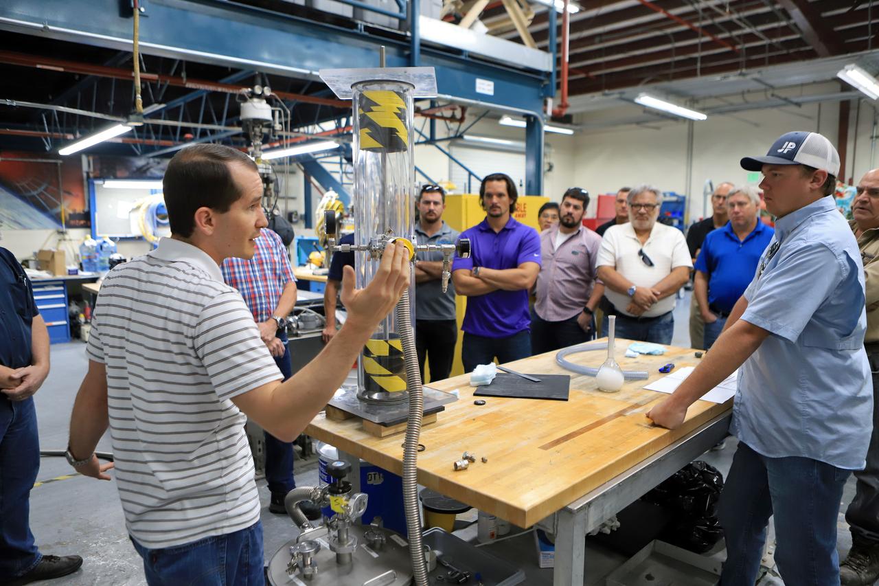 Workers attend a cryogenic insulation training session on Nov. 6, 2018, at the Cryogenics Laboratory at NASA's Kennedy Space Center in Florida. The training is for personnel who will be working to insulate pipes on the mobile launcher (ML). The ML is equipped with cryogenic fluid lines that will deliver hydrogen and oxygen to NASA's Space Launch System rocket. The lines must be kept well-insulated to maintain temperatures cold enough to keep fluids in a liquid state. In a new process, workers are learning how to pack spaces between pipes with aerogel granules in the same manner as they will on the ML.