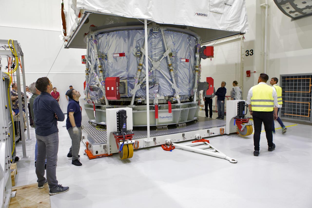 Inside the airlock in the Neil Armstrong Operations and Checkout Building high bay On Nov. 6, 2018, European Space Agency (ESA) and Airbus engineers and technicians watch as a crane is used to uncrate the ESA's European Service Module (ESM) at NASA's Kennedy Space Center in Florida. The ESM will supply the main propulsion system and power to the Orion spacecraft for Exploration Mission-1 (EM-1), a mission to the Moon. The ESM also will house air and water for astronauts on future missions. EM-1 will be an uncrewed flight test that will provide a foundation for human deep space exploration to destinations beyond Earth orbit. EM-1 will be the first integrated test of NASA's Space Launch System, Orion and the ground systems at Kennedy.