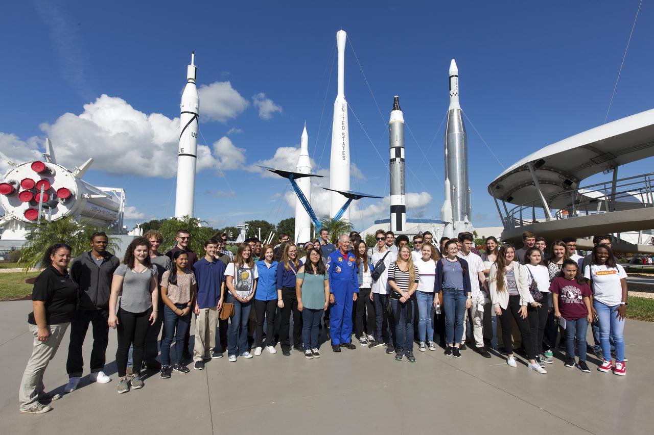 Retired NASA astronaut Bob Springer, center, takes a photograph with top scholars from Brevard County high schools near the Rocket Garden at the NASA Kennedy Space Center Visitor Complex in Florida, on Nov. 7, 2018. The high school seniors were invited to Kennedy Space Center for a tour of facilities, lunch and a roundtable discussion with engineers, scientists and business experts at the center. The 2018 Brevard Top Scholars event was hosted by the center's Academic Engagement Office to honor the top three scholars of the 2018-2019 graduating student class from each of Brevard County’s public high schools. The students received a personalized certificate of recognition at the end of the day.