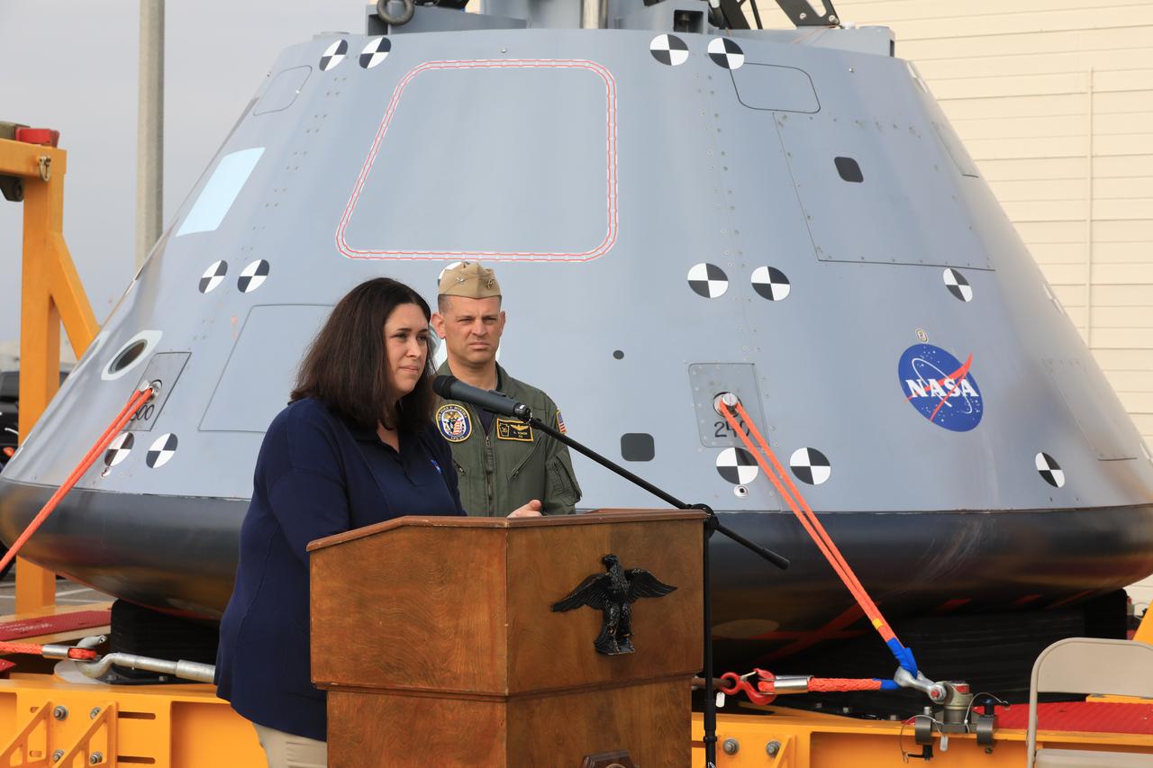 NASA Landing and Recovery Director Melissa Jones briefs the media on the success of Underway Recovery Test-7 on Nov. 7, 2018, at U.S. Naval Base San Diego. Behind her is the test version of the Orion crew module. All of the recovery equipment that was created to safely bring Orion home passed verification and validation testing. The Recovery Team, along with the U.S. Navy, practice recovering the Orion test version as part of URT-7 in the Pacific Ocean. URT-7 is one in a series of tests to verify and validate procedures and hardware that will be used to recover the Orion spacecraft after it splashes down in the Pacific Ocean following deep space exploration missions. Orion will have emergency abort capability, sustain the crew during space travel and provide safe re-entry from deep space return velocities.