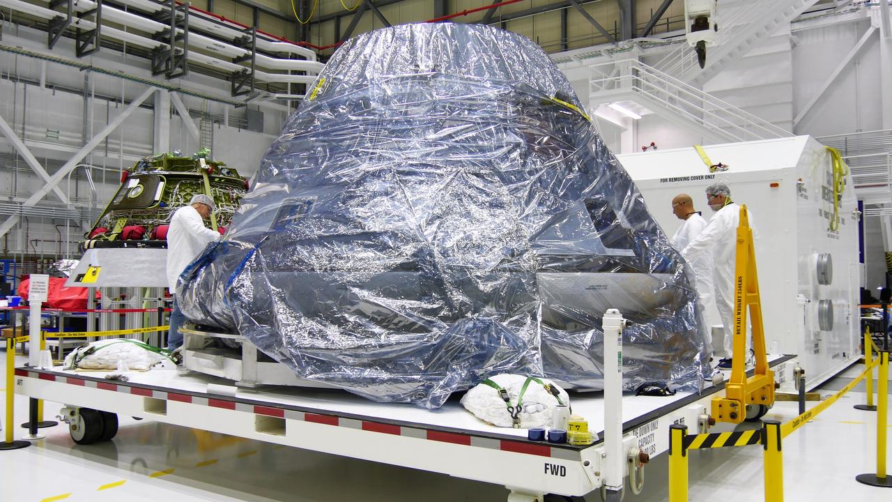 The spacecraft destined to fly astronauts to the International Space Station in Boeing's Crew Flight Test (CFT) is seen Inside the Commercial Crew and Cargo Processing Facility (C3PF) at NASA's Kennedy Space Center in Florida on Nov. 12, 2018. It is surrounded by protective wrapping in preparation for transport to Boeing's testing facilities in El Segundo, California. The company's CST-100 Starliner will be undergoing a series of environmental tests designed to simulate what the spacecraft will experience during different stages of flight as part of NASA's Commercial Crew Program (CCP). The agency's CCP will return human spaceflight launches to U.S. soil, providing safe, reliable and cost-effective access to low-Earth orbit on systems that meet our safety and mission requirements.