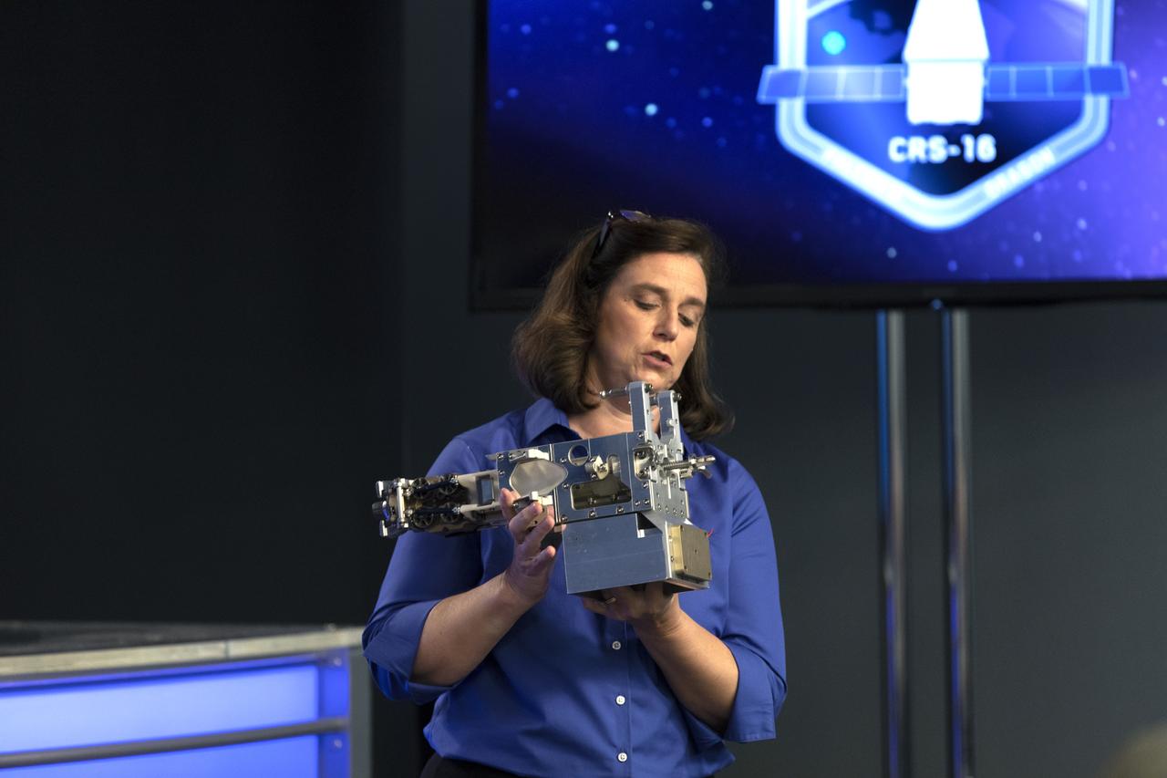 Jill McGuire, project manager for the Robotic Refueling Mission 3, or RRM3, experiment, describes RRM3 hardware for members of the media in the Kennedy Space Center’s Press Site auditorium. The briefing focused on research planned for launch to the International Space Station. The scientific materials and supplies will be aboard a Dragon spacecraft scheduled for liftoff from Cape Canaveral Air Force Station's Space Launch Complex 40. The SpaceX Falcon 9 rocket will launch the company's 16th Commercial Resupply Services mission to the space station.
