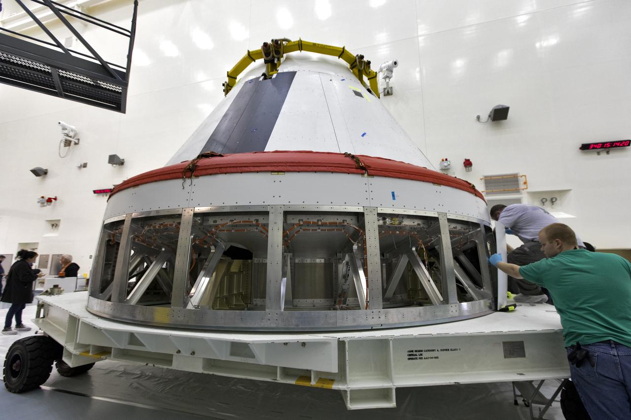 Workers remove cover plates from a mock Orion crew module inside the Multi-Payload Processing Facility at NASA’s Kennedy Space Center in Florida on Dec. 6, 2018. The crew module will be used during a full stress test of the Launch Abort System (LAS), called Ascent Abort-2 (AA-2), scheduled for April 2019. During the test, the Northrop Grumman booster will launch from Space Launch Complex 46, carrying a fully functional LAS and the 22,000-pound Orion test vehicle to an altitude of 31,000 feet and traveling at more than 1,000 miles an hour. The test will verify the LAS can steer the crew module and astronauts aboard to safety in the event of an issue with the Space Launch System (SLS) rocket when the spacecraft is under the highest aerodynamic loads it will experience during a rapid climb into space.