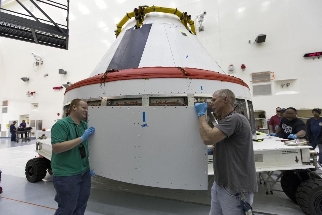 Workers remove cover plates from a mock Orion crew module inside the Multi-Payload Processing Facility at NASA’s Kennedy Space Center in Florida on Dec. 6, 2018. The crew module will be used during a full stress test of the Launch Abort System (LAS), called Ascent Abort-2 (AA-2), scheduled for April 2019. During the test, the Northrop Grumman booster will launch from Space Launch Complex 46, carrying a fully functional LAS and the 22,000-pound Orion test vehicle to an altitude of 31,000 feet and traveling at more than 1,000 miles an hour. The test will verify the LAS can steer the crew module and astronauts aboard to safety in the event of an issue with the Space Launch System (SLS) rocket when the spacecraft is under the highest aerodynamic loads it will experience during a rapid climb into space.