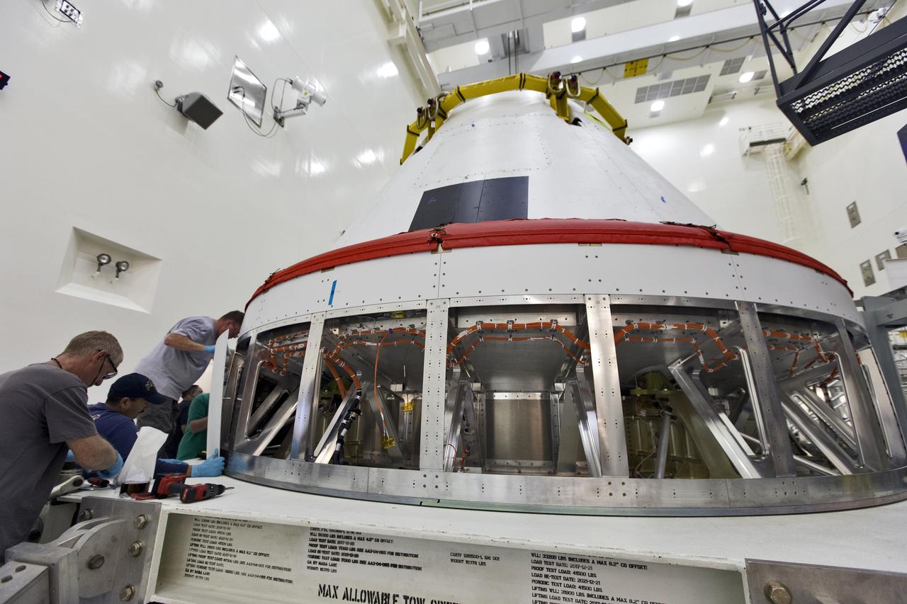 Workers remove cover plates from a mock Orion crew module inside the Multi-Payload Processing Facility at NASA’s Kennedy Space Center in Florida on Dec. 6, 2018. The crew module will be used during a full stress test of the Launch Abort System (LAS), called Ascent Abort-2 (AA-2), scheduled for April 2019. During the test, the booster will launch from Space Launch Complex 46, carrying a fully functional LAS and the 22,000-pound Orion test vehicle to an altitude of 31,000 feet and traveling at more than 1,000 miles an hour. The test will verify the LAS can steer the crew module and astronauts aboard to safety in the event of an issue with the Space Launch System (SLS) rocket when the spacecraft is under the highest aerodynamic loads it will experience during a rapid climb into space.