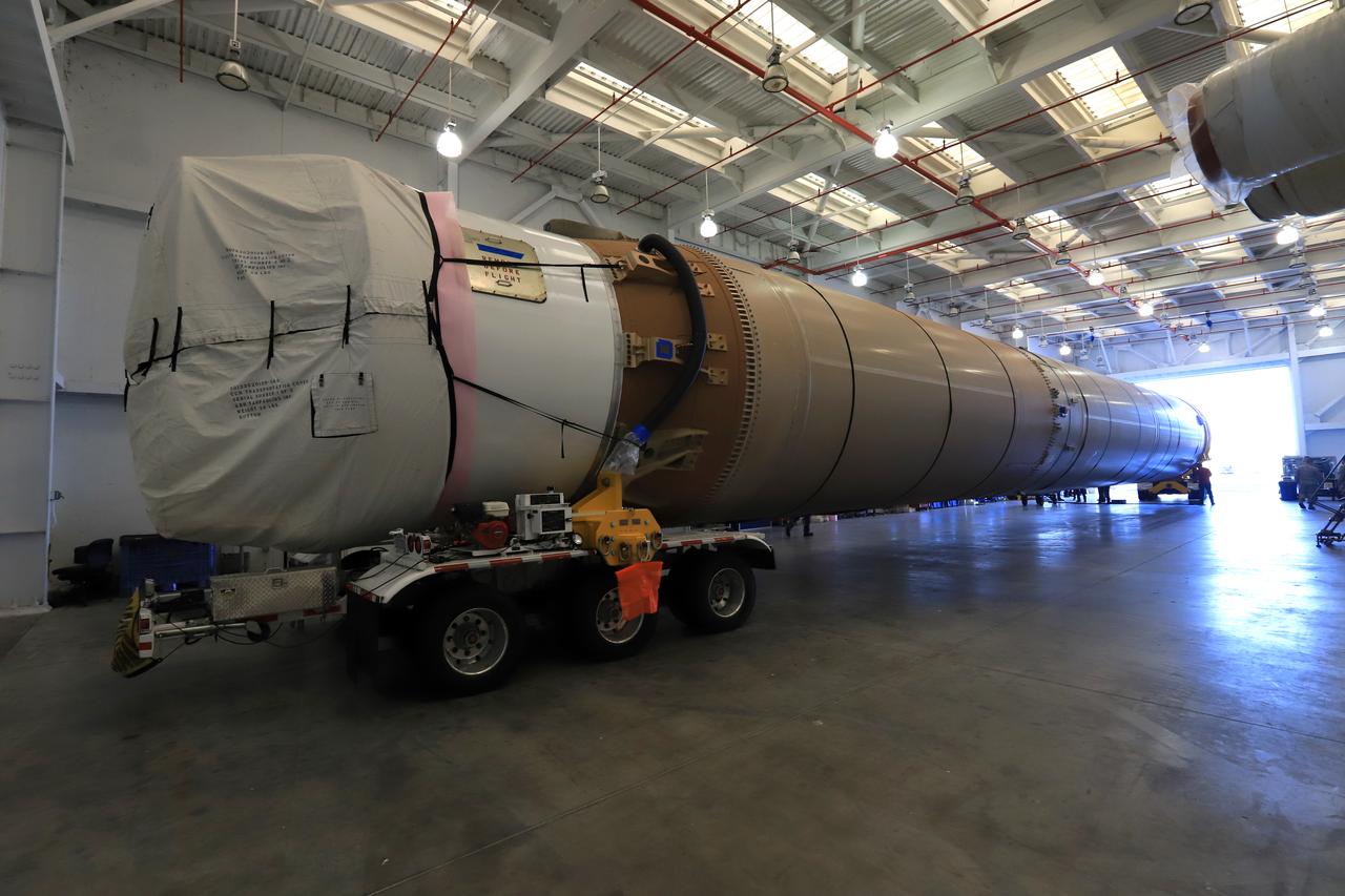 The first stage of the rocket that will launch Boeing's CST-100 Starliner spacecraft to the International Space Station on the company's uncrewed Orbital Flight Test arrives at the United Launch Alliance (ULA) Atlas Spaceflight Operations Center (ASOC) at Cape Canaveral Air Force Station in Florida on Dec. 7, 2018. The ULA Atlas V first stage booster was shipped aboard the company's Mariner cargo vessel from the company's manufacturing plant in Decatur, Alabama. It is the final piece of hardware that ULA needs to launch the first Boeing Starliner. Inside the ASOC, the booster will be inspected and checked out.