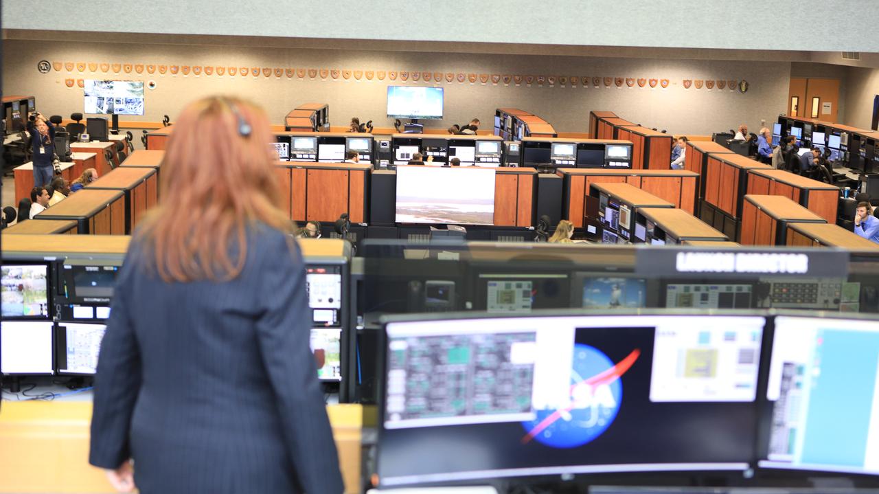 NASA Launch Director Charlie Blackwell-Thompson looks out over Firing Room 1 in the Launch Control Center at NASA’s Kennedy Space Center in Florida during a terminal countdown demonstration for Exploration Mission 1, or EM-1, on Dec. 14, 2018. The launch will be the first integrated test of the Space Launch System rocket and Orion spacecraft that will eventually take astronauts beyond low-Earth orbit to destinations such as the Moon and Mars. The countdown demonstration was intended to validate the launch team's capability to perform an EM-1 countdown and respond to challenges put into the system for practice.