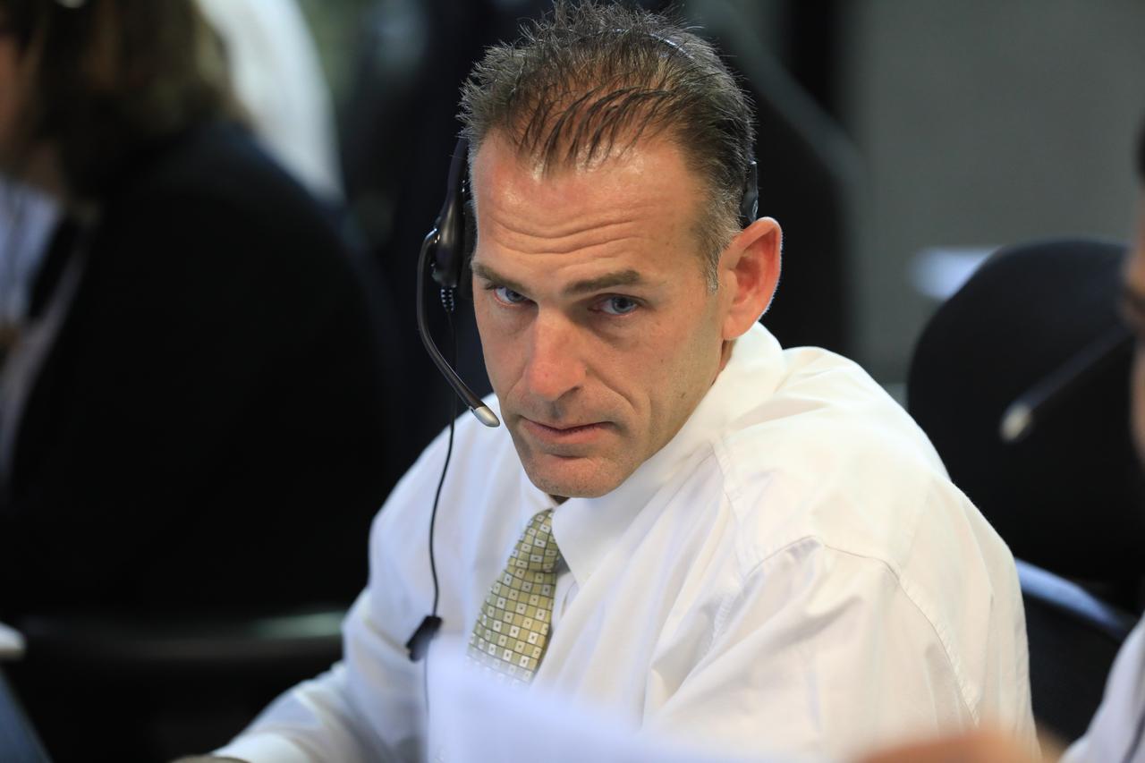 Mark Tripp, center, monitors his console in Firing Room 1 in the Launch Control Center at NASA’s Kennedy Space Center in Florida, during a terminal countdown demonstration for Exploration Mission 1, or EM-1, on Dec. 14, 2018. The launch will be the first integrated test of the Space Launch System rocket and Orion spacecraft that will eventually take astronauts beyond low-Earth orbit to destinations such as the Moon and Mars. The countdown demonstration was intended to validate the launch team's capability to perform an EM-1 countdown and respond to challenges put into the system for practice.