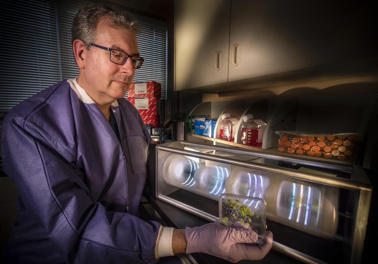 Jeffrey Richards, project science coordinator and research scientist at NASA’s Kennedy Space Center in Florida, demonstrates how Arabidopsis thaliana plant samples are tested in a 2D microgravity simulator in the Microgravity Simulation Support Facility on Dec. 20, 2018.