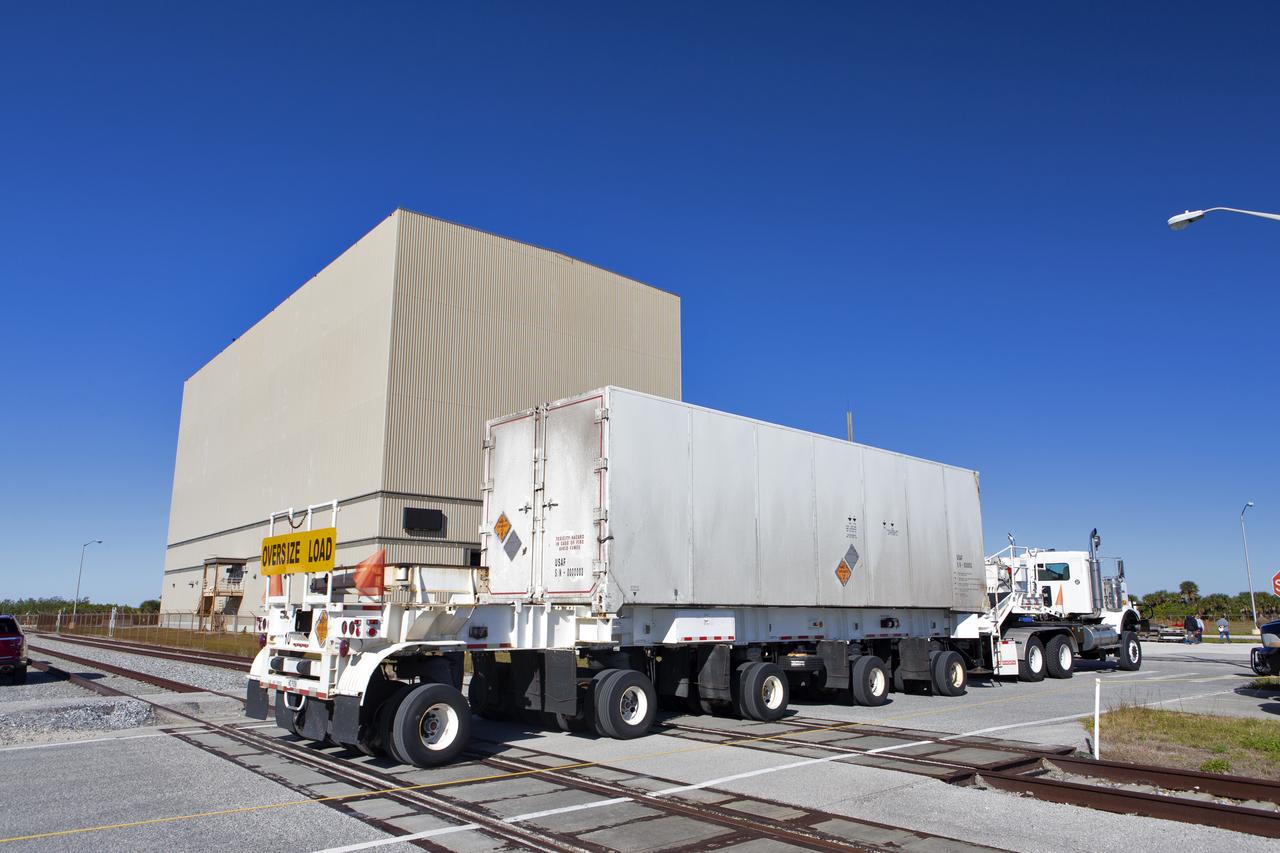 A heavy transport truck containing the Northrop Grumman-provided ascent test booster for the Orion Ascent Abort-2 (AA-2) Flight Test, arrives at the Rotation, Processing and Surge Facility (RPSF) at NASA’s Kennedy Space Center in Florida on Jan. 29, 2019. The booster will be unloaded and moved into the RPSF where it will be outfitted for flight. AA-2 is a full-stress test of the Launch Abort System, scheduled for April 2019. AA-2 will launch from Space Launch Complex 46, carrying a fully functional LAS and a 22,000-pound Orion test vehicle to an altitude of 31,000 feet and traveling at more than 1,000 miles an hour. The test will verify the LAS can steer the crew module and astronauts aboard to safety in the event of an issue with the Space Launch System (SLS) rocket when the spacecraft is under the highest aerodynamic loads it will experience during a rapid climb into space. NASA's Orion and Exploration Ground Systems programs and contractors from Jacob's and Northrup Grumman in conjunction with the Air Force Space and Missile Center's Launch Operations branch are performing flight operations for AA-2.