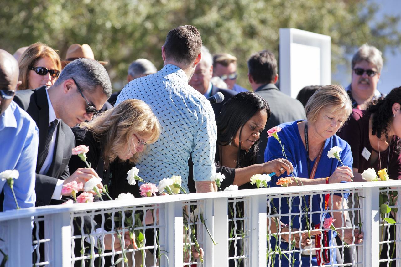 Guests place flowers in front of the Space Mirror Memorial at the Kennedy Space Center Visitor Complex during this year’s Day of Remembrance ceremony. The memorial, a 42-foot-high by 50-foot-wide granite monument, displays the names of the fallen astronauts from Apollo 1, space shuttles Challenger and Columbia, as well as others who have lost their lives while on NASA missions or in training. Each year, Kennedy employees and guests gather with others throughout NASA to honor those astronauts who have fallen in the pursuit of space exploration.