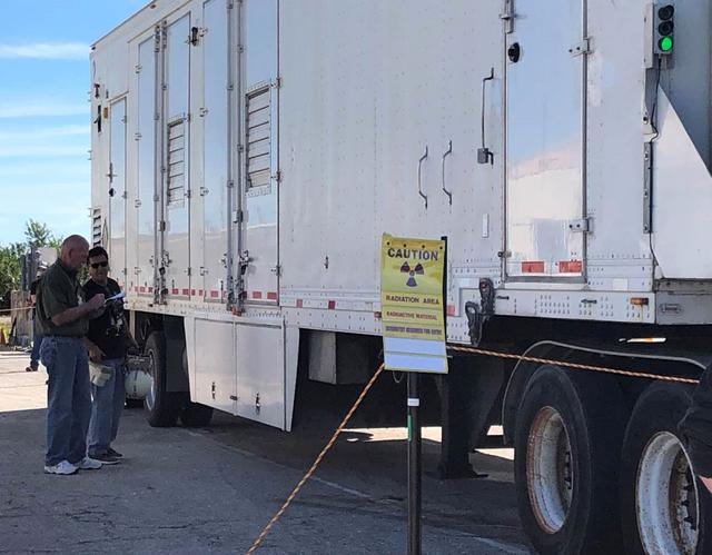 NASA Kennedy Space Center’s Health Physics team sets up a simulated radiation control boundary around the trailer carrying a multi-mission radioisotope thermoelectric generator (MMRTG) simulator on Feb. 7, 2019. NASA’s Mars 2020 rover will be powered by an MMRTG. The arrival of the MMRTG simulator enables the team to practice radiation control and monitoring protocols, including setting up radiation control points and postings around the trailer prior. 