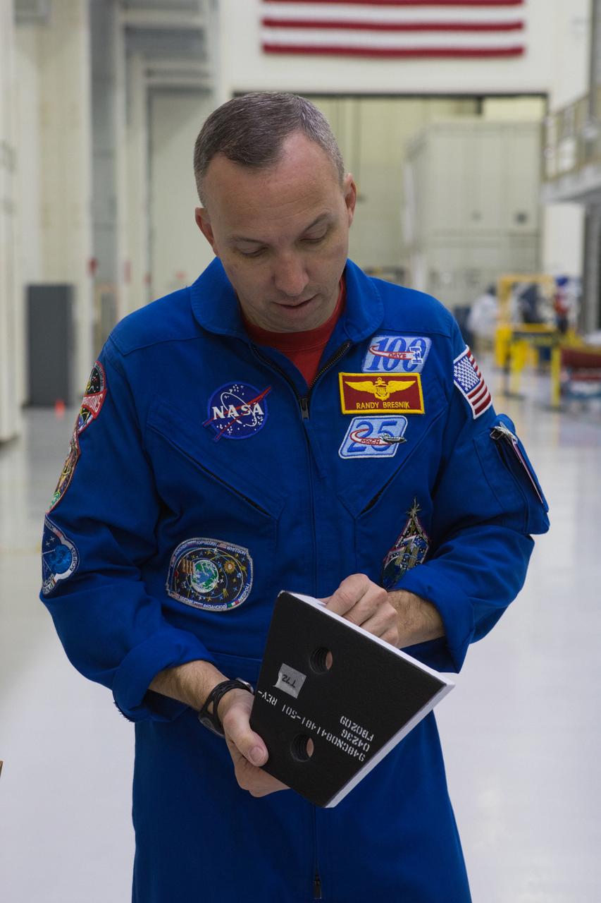 NASA astronaut Randy Bresnik examines a heat-resistant tile sample inside the Operations and Checkout Building high bay at NASA’s Kennedy Space Center in Florida during a tour on Feb. 12, 2019. Bresnik also viewed additional spaceflight hardware being processed for Exploration Mission-1 and Exploration Mission-2.