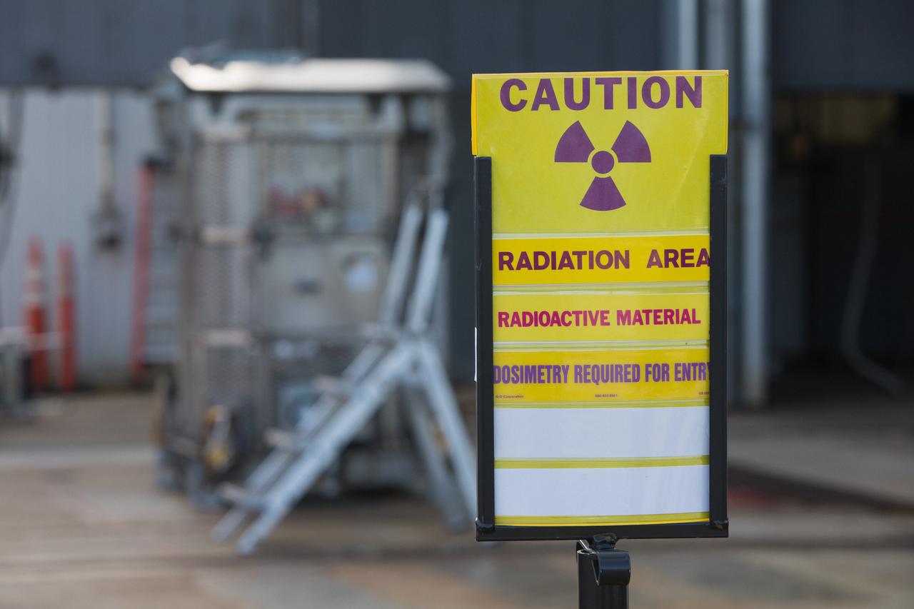 A caution sign marks the presence of a test version of the Multi-Mission Radioisotope Thermoelectric Generator (MMRTG) for NASA’s Mars 2020 mission at the United Launch Alliance Vertical Integration Facility (VIF) at Space Launch Complex 41 at Cape Canaveral Air Force Station in Florida on Feb. 15, 2019. The MMRTG simulator will be used to practice operations and procedures for carefully hoisting it up and into the VIF. The Mars 2020 rover mission is targeted to launch in July 2020 on a ULA Atlas V rocket from Pad 41. Mars 2020 is part of NASA’s Mars Exploration Program, a long-term effort of robotic exploration of the Red Planet. The rover will search for habitable conditions in the ancient past and signs of past microbial life on Mars.