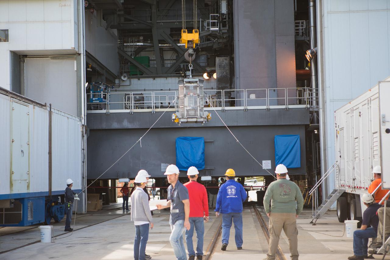 Technicians assist as a crane lifts up a test version of the Multi-Mission Radioisotope Thermoelectric Generator (MMRTG) for NASA’s Mars 2020 mission at the United Launch Alliance Vertical Integration Facility (VIF) at Space Launch Complex 41 at Cape Canaveral Air Force Station in Florida on Feb. 15, 2019. The MMRTG simulator is being used to practice operations and procedures for carefully hoisting it up and into the VIF. The Mars 2020 rover mission is targeted to launch in July 2020 on a ULA Atlas V rocket from Pad 41. Mars 2020 is part of NASA’s Mars Exploration Program, a long-term effort of robotic exploration of the Red Planet. The rover will search for habitable conditions in the ancient past and signs of past microbial life on Mars.