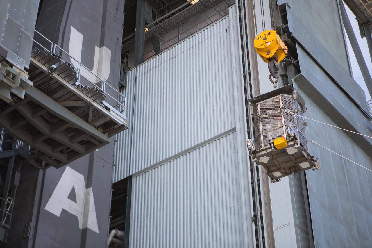 A crane is used to hoist a test version of the Multi-Mission Radioisotope Thermoelectric Generator (MMRTG) for NASA’s Mars 2020 mission at the United Launch Alliance Vertical Integration Facility (VIF) at Space Launch Complex 41 at Cape Canaveral Air Force Station in Florida on Feb. 15, 2019. The MMRTG simulator is being used to practice operations and procedures for carefully lifting it up and into the VIF. The Mars 2020 rover mission is targeted to launch in July 2020 on a ULA Atlas V rocket from Pad 41. Mars 2020 is part of NASA’s Mars Exploration Program, a long-term effort of robotic exploration of the Red Planet. The rover will search for habitable conditions in the ancient past and signs of past microbial life on Mars.
