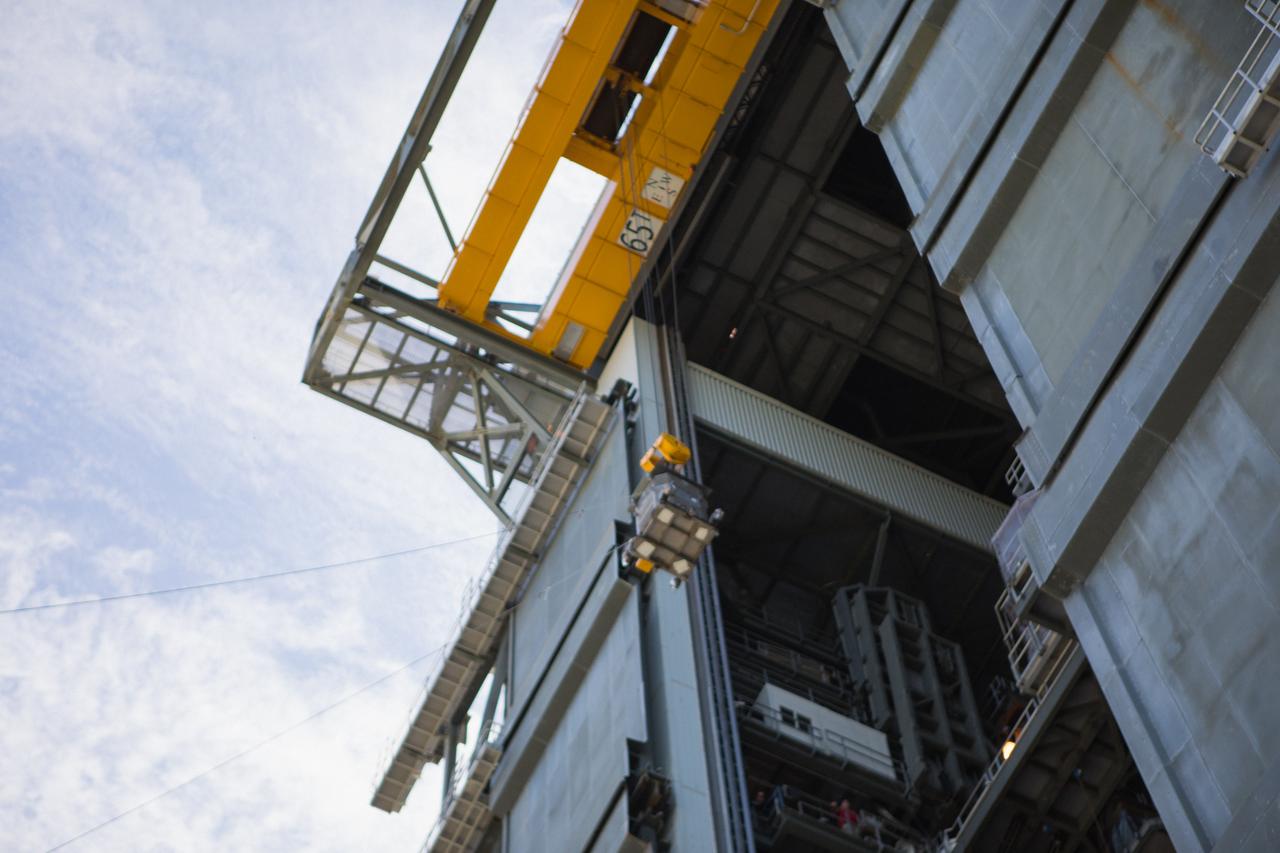 A crane is used to hoist a test version of the Multi-Mission Radioisotope Thermoelectric Generator (MMRTG) for NASA’s Mars 2020 mission at the United Launch Alliance Vertical Integration Facility (VIF) at Space Launch Complex 41 at Cape Canaveral Air Force Station in Florida on Feb. 15, 2019. The MMRTG simulator is being used to practice operations and procedures for carefully lifting it up and into the VIF. The Mars 2020 rover mission is targeted to launch in July 2020 on a ULA Atlas V rocket from Pad 41. Mars 2020 is part of NASA’s Mars Exploration Program, a long-term effort of robotic exploration of the Red Planet. The rover will search for habitable conditions in the ancient past and signs of past microbial life on Mars.
