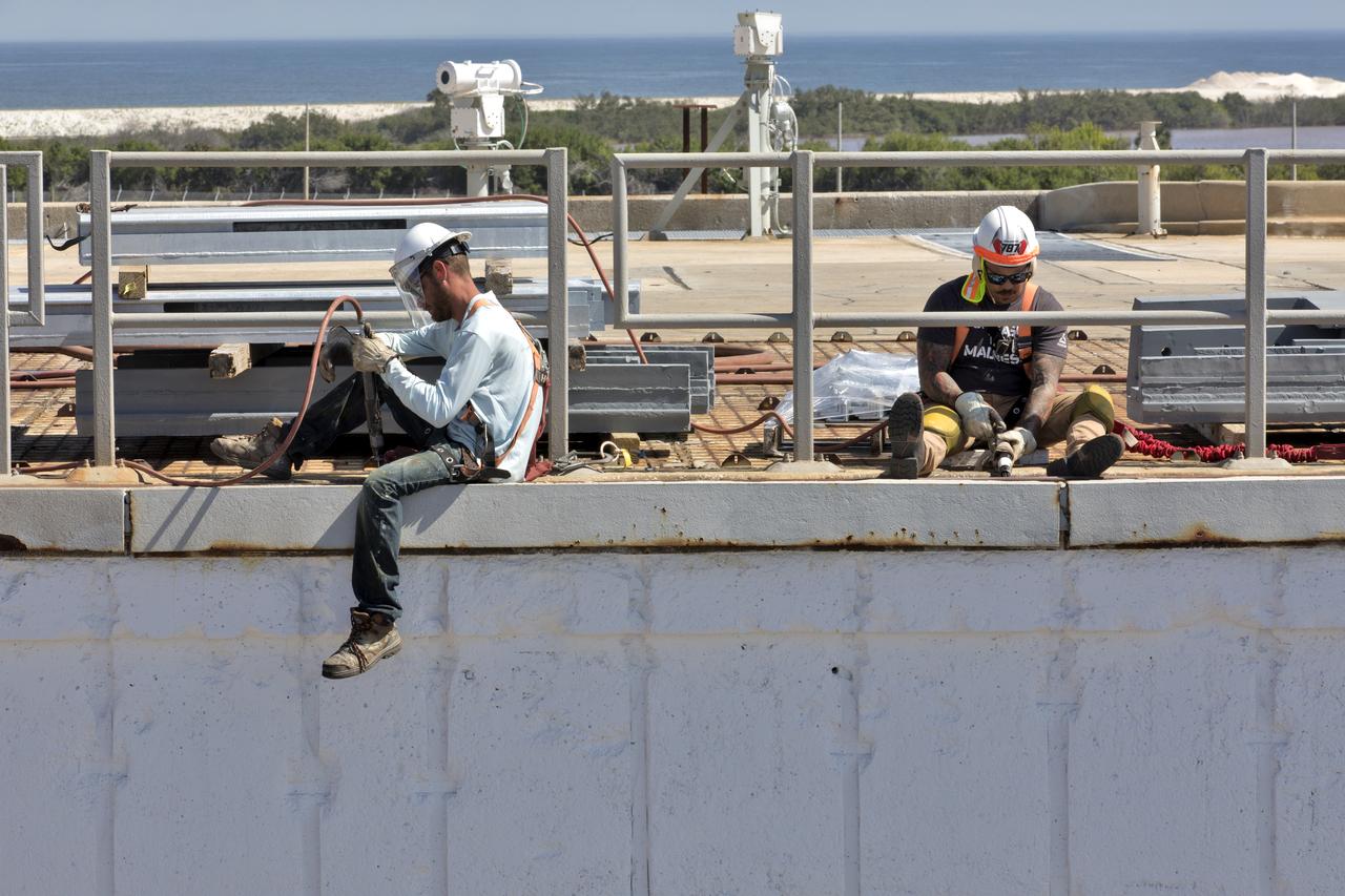 Constructions workers are busy repairing the concrete on the surface of Launch Pad 39B at NASA’s Kennedy Space Center in Florida on Feb. 22, 2019. The launch pad has undergone upgrades and modifications to accommodate NASA's Space Launch System and Orion spacecraft for Exploration Mission-1 and subsequent missions. Upgrades include new heat-resistant bricks on the walls of the flame trench and installation of a new flame deflector. All of the upgrades have been managed by Exploration Ground Systems.