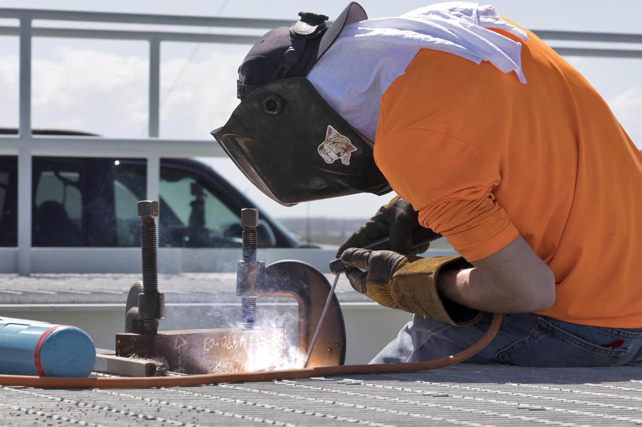 A construction worker welds a section of metal on the surface of Launch Pad 39B at NASA’s Kennedy Space Center in Florida on Feb. 22, 2019. The launch pad has undergone upgrades and modifications to accommodate NASA's Space Launch System and Orion spacecraft for Exploration Mission-1 and subsequent missions. Upgrades include new heat-resistant bricks on the walls of the flame trench and installation of a new flame deflector. All of the upgrades have been managed by Exploration Ground Systems.