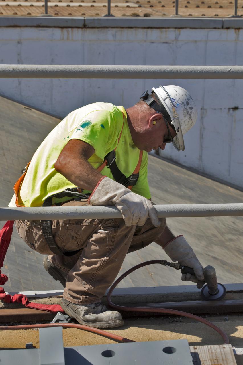 A construction worker sands a section of a wood beam on the surface of Launch Pad 39B at NASA’s Kennedy Space Center in Florida on Feb. 22, 2019. The launch pad has undergone upgrades and modifications to accommodate NASA's Space Launch System and Orion spacecraft for Exploration Mission-1 and subsequent missions. Upgrades include new heat-resistant bricks on the walls of the flame trench and installation of a new flame deflector. All of the upgrades have been managed by Exploration Ground Systems.