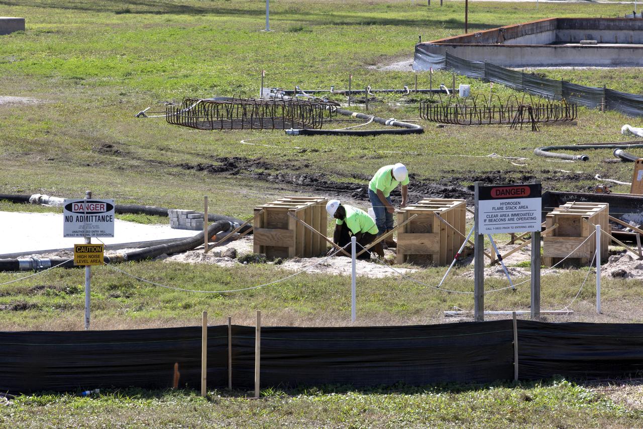 Construction workers stage parts and equipment nearby Launch Pad 39B at NASA’s Kennedy Space Center in Florida on Feb. 22, 2019. The launch pad has undergone upgrades and modifications to accommodate NASA's Space Launch System and Orion spacecraft for Exploration Mission-1 and subsequent missions. Upgrades include new heat-resistant bricks on the walls of the flame trench and installation of a new flame deflector. All of the upgrades have been managed by Exploration Ground Systems.