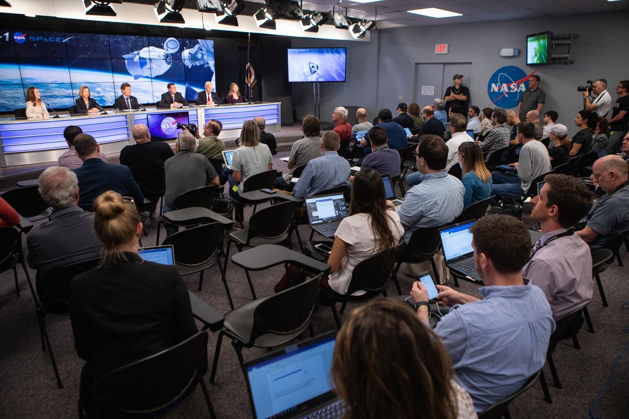 In the Kennedy Space Center’s Press Site TV auditorium, NASA, SpaceX and the 45th Weather Squadron leaders speak to members of the media during a prelaunch news conference Thursday, Feb. 28, prior to the Saturday, March 2 launch of the SpaceX Demo-1 Commercial Crew Program (CCP) mission to the International Space Station. From left are:  Stephanie Martin of NASA Communications, Kathy Lueders, manager, NASA’s Commercial Crew Program; Hans Koenigsmann, vice president, Build and Flight Reliability, SpaceX; Joel Montalbano, deputy manager, International Space Station Program; Pat Forrester, chief, Astronaut Office, Johnson Space Center; and Melody C. Lovin, launch weather officer, 45th Weather Squadron. The inaugural flight of the SpaceX Crew Dragon, known as Demo-1, is scheduled to lift off from Kennedy’s Launch Complex 39A Saturday at 2:49 EST. A SpaceX Falcon 9 rocket will launch the uncrewed spacecraft on a mission designed to validate end-to-end systems and capabilities, leading to certification to fly crew. NASA has worked with SpaceX and Boeing in developing the Commercial Crew Program spacecraft to facilitate new human spaceflight systems launching from U.S. soil with the goal of safe, reliable and cost-effective access to low-Earth orbit destinations, such as the International Space Station. 