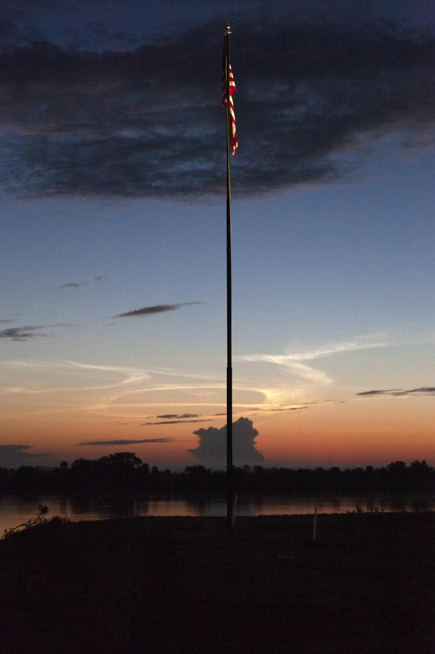 A sunrise serves as the backdrop for the American Flag near the Press Site at NASA’s Kennedy Space Center in Florida following the successful launch of SpaceX’s uncrewed Demo-1 flight test from Launch Complex 39A on March 2, 2019. The company’s Crew Dragon spacecraft lifted off atop a Falcon 9 rocket and traveled to the International Space Station, where it validated end-to-end systems and capabilities in preparation for certification to fly crew. 