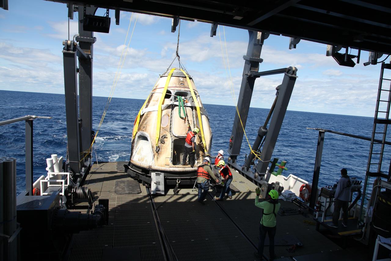 SpaceX’s Crew Dragon is loaded onto the company’s recovery ship, Go Searcher, in the Atlantic Ocean, about 200 miles off Florida’s east coast, on March 8, after returning from the International Space Station on the Demo-1 mission. The uncrewed spacecraft docked to the orbiting laboratory on March 3, following a 2:49 a.m. EST liftoff aboard a SpaceX Falcon 9 rocket from Launch Complex 39A at NASA’s Kennedy Space Center in Florida on March 2. The spacecraft undocked at 2:32 a.m., March 8, splashing down in the Atlantic Ocean, at 8:45 a.m. SpaceX’s inaugural flight with NASA’s Commercial Crew Program is the first flight test of a space system designed for humans built and operated by a commercial company through a public-private partnership. NASA and SpaceX will use data from Demo-1 to further prepare for Demo-2, the crewed flight test that will carry NASA astronauts Bob Behnken and Doug Hurley to the International Space Station later this year.