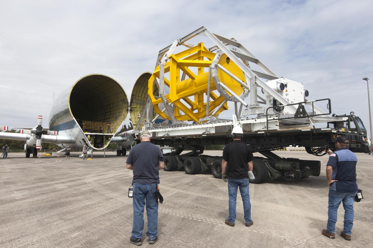 A fit check of the Orion Crew and Service Module Horizontal Transporter (CHT) with NASA's Super Guppy aircraft began March 12, 2019, at NASA Kennedy Space Center’s Shuttle Landing Facility in Florida, operated by Space Florida. In this photo, the Super Guppy’s payload bay is opened as the CHT, secured on the U.S. Air Force aircraft loader, is moved toward the aircraft. The fit check is being performed to confirm loading operations, ensure that the CHT fits inside the Super Guppy and test the electrical interface to aircraft power. The Orion crew and service modules will be readied for a trip to NASA’s Plum Brook Station in Sandusky, Ohio, for full thermal vacuum testing. In this unique facility, the crew and service modules will be put through extensive testing to ensure they can survive the rigors of launch, space travel, re-entry and splashdown. The Orion spacecraft will launch atop the agency's Space Launch System rocket on Exploration Mission-1. 
