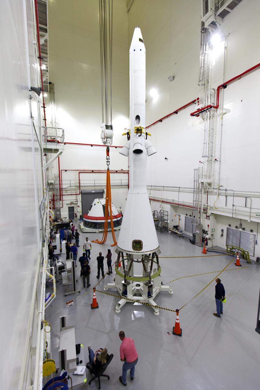 A test version of the Orion crew module is integrated with the Launch Abort System (LAS) in the Launch Abort System Facility (LASF) at NASA’s Kennedy Space Center in Florida on March 13, 2019. Workers will use a crane to practice lifting the test vehicle. The LAS, in view, will be used for the Orion Ascent Abort-2 (AA-2) Flight Test. AA-2 is a full-stress test of the LAS, scheduled for spring 2019. AA-2 will launch from Space Launch Complex 46, carrying a fully functional LAS and a 22,000-pound Orion test vehicle to an altitude of 31,000 feet and traveling at more than 1,000 miles an hour. The test will verify the LAS can steer the crew module and astronauts aboard to safety in the event of an issue with the Space Launch System (SLS) rocket when the spacecraft is under the highest aerodynamic loads it will experience during a rapid climb into space. NASA's Orion and Exploration Ground Systems programs and contractors from Jacob's and Northrop Grumman in conjunction with the Air Force Space and Missile Center's Launch Operations branch are performing flight operations for AA-2.