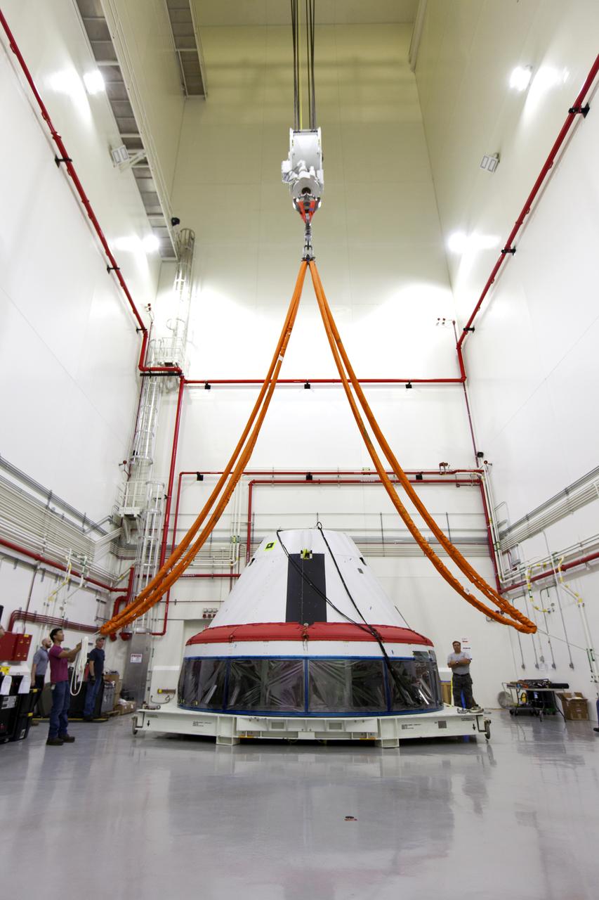 Inside the Launch Abort System Facility (LASF) at NASA’s Kennedy Space Center in Florida, workers prepare to attach a crane to a test version of the Orion crew module on March 13, 2019. The Orion test module and the Launch Abort System will be used for the Orion Ascent Abort-2 (AA-2) Flight Test, a full-stress test of the LAS, scheduled for spring 2019. AA-2 will launch from Space Launch Complex 46, carrying a fully functional LAS and a 22,000-pound Orion test vehicle to an altitude of 31,000 feet and traveling at more than 1,000 miles an hour. The test will verify the LAS can steer the crew module and astronauts aboard to safety in the event of an issue with the Space Launch System (SLS) rocket when the spacecraft is under the highest aerodynamic loads it will experience during a rapid climb into space. NASA's Orion and Exploration Ground Systems programs and contractors from Jacob's and Northrop Grumman in conjunction with the Air Force Space and Missile Center's Launch Operations branch are performing flight operations for AA-2.