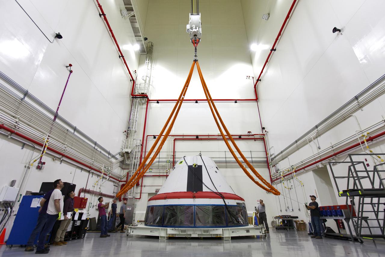 Inside the Launch Abort System Facility (LASF) at NASA’s Kennedy Space Center in Florida, workers prepare to attach a crane to a test version of the Orion crew module on March 13, 2019. The Orion test module and the Launch Abort System will be used for the Orion Ascent Abort-2 (AA-2) Flight Test, a full-stress test of the LAS, scheduled for spring 2019. AA-2 will launch from Space Launch Complex 46, carrying a fully functional LAS and a 22,000-pound Orion test vehicle to an altitude of 31,000 feet and traveling at more than 1,000 miles an hour. The test will verify the LAS can steer the crew module and astronauts aboard to safety in the event of an issue with the Space Launch System (SLS) rocket when the spacecraft is under the highest aerodynamic loads it will experience during a rapid climb into space. NASA's Orion and Exploration Ground Systems programs and contractors from Jacob's and Northrop Grumman in conjunction with the Air Force Space and Missile Center's Launch Operations branch are performing flight operations for AA-2.