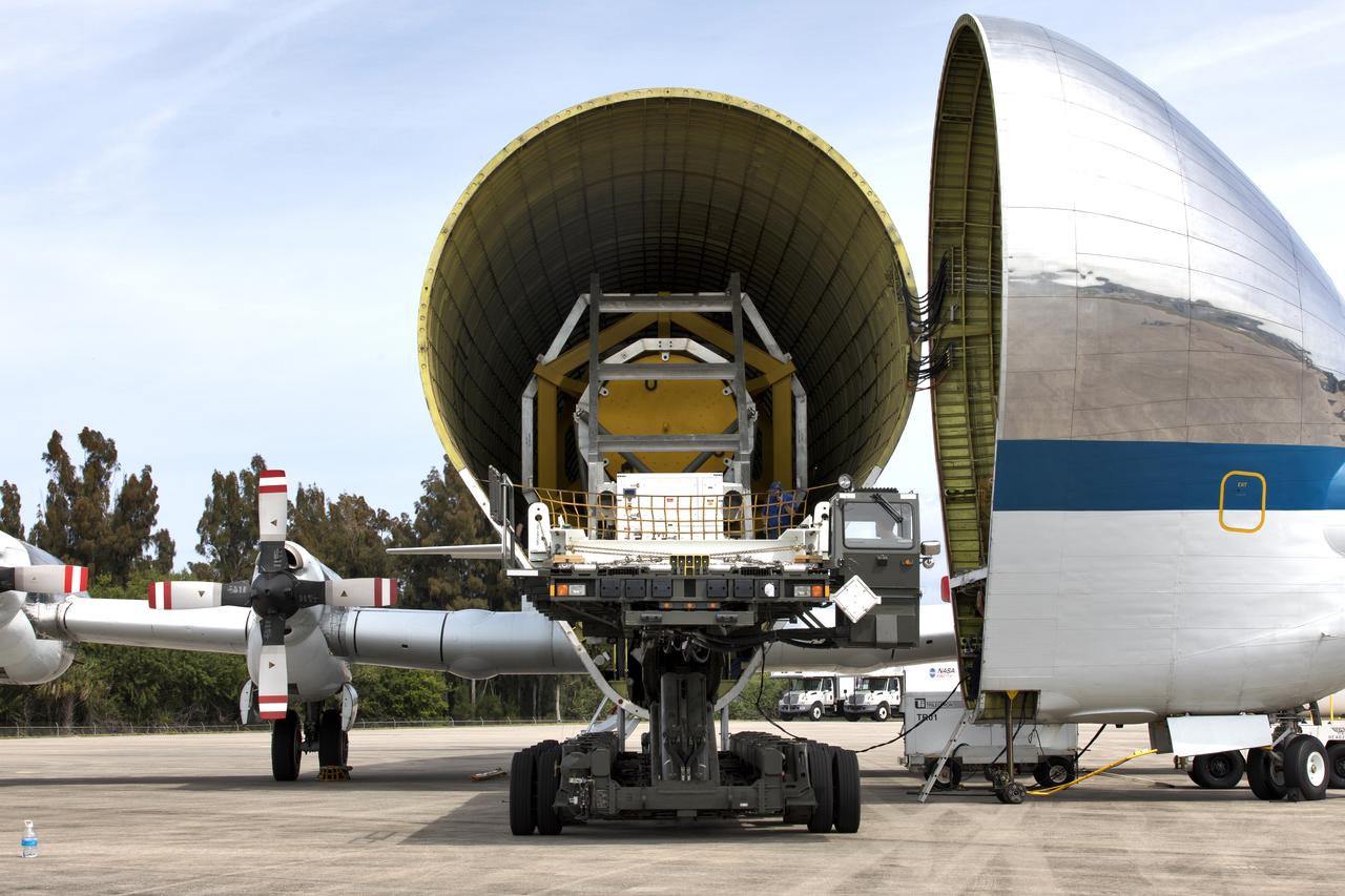 A fit check of the Orion Crew and Service Module Horizontal Transporter (CHT) with NASA's Super Guppy aircraft is underway March 13, 2019, at NASA Kennedy Space Center’s Shuttle Landing Facility in Florida, operated by Space Florida. In this photo, the CHT, secured on the U.S. Air Force aircraft loader, is moved inside the aircraft’s payload bay. The fit check is being performed to confirm loading operations, ensure that the CHT fits inside the Super Guppy and test the electrical interface to aircraft power. The Orion crew and service modules will be readied for a trip to NASA’s Plum Brook Station in Sandusky, Ohio, for full thermal vacuum testing. In this unique facility, the crew and service modules will be put through extensive testing to ensure they can survive the rigors of launch, space travel, re-entry and splashdown. The Orion spacecraft will launch atop the agency's Space Launch System rocket on Exploration Mission-1. 