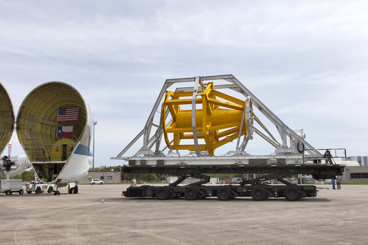 A fit check of the Orion Crew and Service Module Horizontal Transporter (CHT) with NASA's Super Guppy aircraft is underway March 13, 2019, at NASA Kennedy Space Center’s Shuttle Landing Facility in Florida, operated by Space Florida. In this photo, the CHT is secured on the U.S. Air Force aircraft loader and is being moved toward the Super Guppy. The fit check is being performed to confirm loading operations, ensure that the CHT fits inside the Super Guppy and test the electrical interface to aircraft power. The Orion crew and service modules will be readied for a trip to NASA’s Plum Brook Station in Sandusky, Ohio, for full thermal vacuum testing. In this unique facility, the crew and service modules will be put through extensive testing to ensure they can survive the rigors of launch, space travel, re-entry and splashdown. The Orion spacecraft will launch atop the agency's Space Launch System rocket on Exploration Mission-1. 