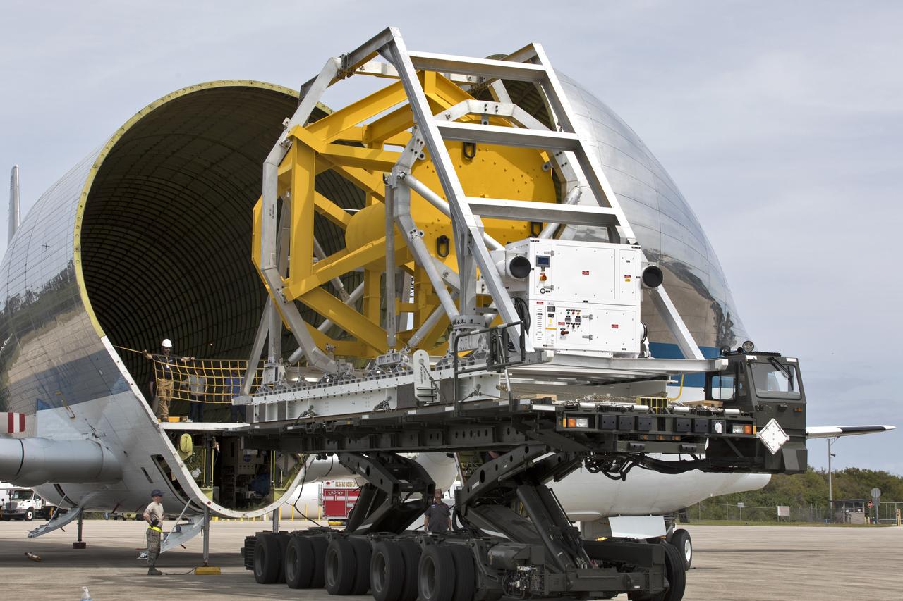 A fit check of the Orion Crew and Service Module Horizontal Transporter (CHT) with NASA's Super Guppy aircraft is underway March 13, 2019, at NASA Kennedy Space Center’s Shuttle Landing Facility in Florida, operated by Space Florida. In this photo, the Super Guppy’s payload bay has been opened and the CHT, secured on the U.S. Air Force aircraft loader, is moved inside the aircraft’s payload bay. The fit check is being performed to confirm loading operations, ensure that the CHT fits inside the Super Guppy and test the electrical interface to aircraft power. The Orion crew and service modules will be readied for a trip to NASA’s Plum Brook Station in Sandusky, Ohio, for full thermal vacuum testing. In this unique facility, the crew and service modules will be put through extensive testing to ensure they can survive the rigors of launch, space travel, re-entry and splashdown. The Orion spacecraft will launch atop the agency's Space Launch System rocket on Exploration Mission-1. 