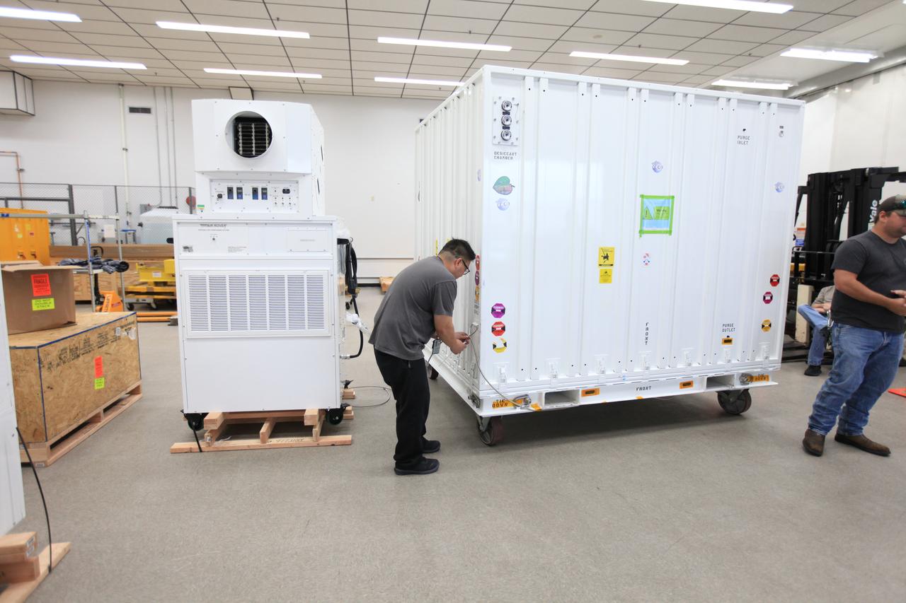 Workers prepare to move NASA’s Orbiting Carbon Observatory 3, or OCO-3, payload container out of the Space Station Processing Facility high bay at the agency’s Kennedy Space Center in Florida onto a truck that will transport it to the SpaceX facility on March 18, 2019. The OCO-3 payload will be stowed in the trunk of SpaceX’s Dragon spacecraft, where it will launch aboard a Falcon 9 rocket on the company’s 17th Commercial Resupply Services mission to the International Space Station. Launch is scheduled for April 25, 2019, from Launch Complex 40 at Cape Canaveral Air Force Station. Once the payload reaches the station, it will be removed from Dragon and robotically installed on the exterior of the orbiting laboratory’s Japanese Experiment Module Exposed Facility Unit, where it will measure and map carbon dioxide from space to provide further understanding of the relationship between carbon and climate. 
